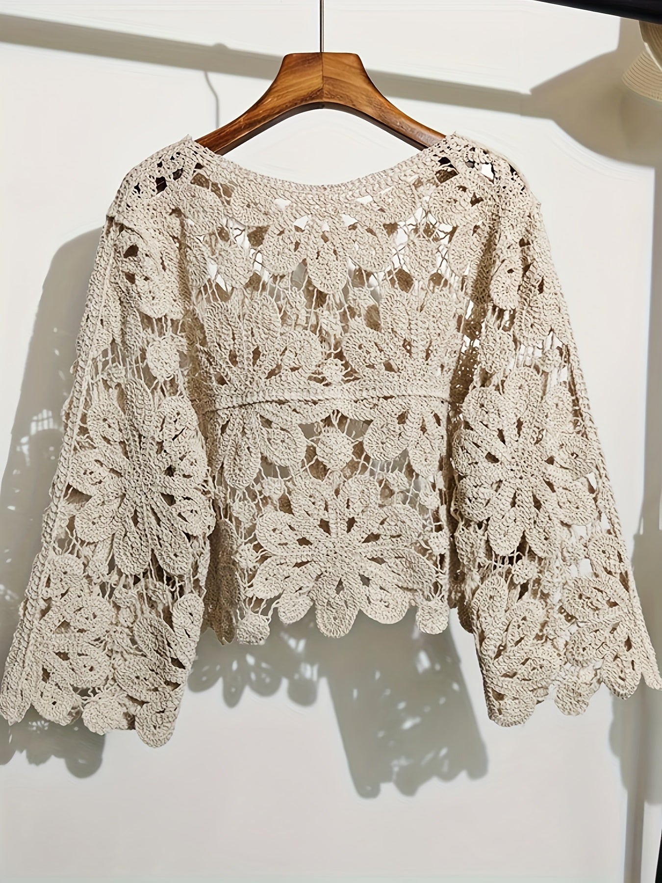 This Artistic Jacquard Cardigan Features Crocheted Openwork That Illustrates a Fanciful Paradise. Detailed Embroidery That Looks Like Vines Surrounds The Hem